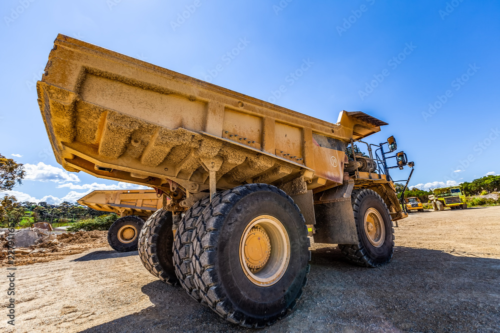 Obraz premium Dumper trucks on construction site on bright sunny day