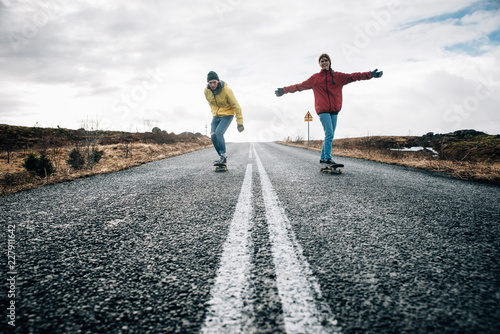 Couple of teenagers having fun skating and making downhill in Iceland © oneinchpunch