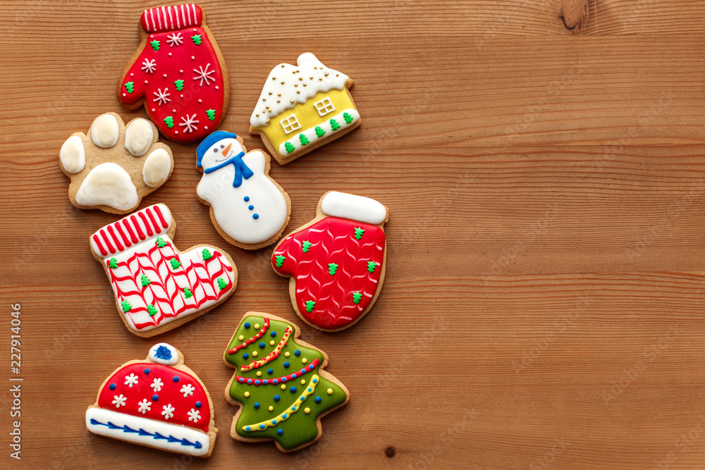 Colorful christmas cookies set lay on wooden table. Holidays food and decoration concept.