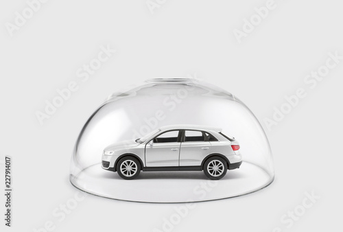 Modern silver car protected under a glass dome 