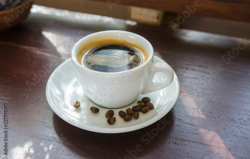 Black coffee on a wooden table in a coffee shop