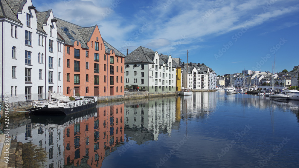 View of the famous clear blue canal lined up with the Art Nouveau buildings, the entire town being rebuilt in this architectural style after a terrific fire in 1904 , in Alesund, Norway