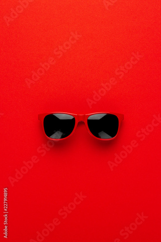studio shot of red sunglasses. summer is coming concept. vertical orientation