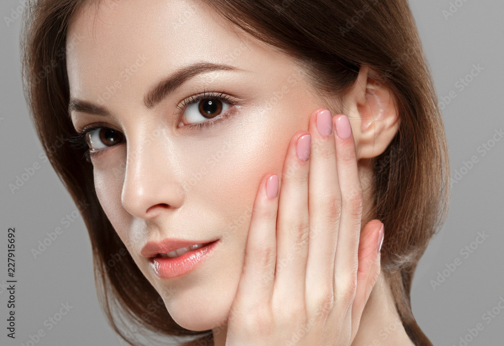 Beauty woman face hair skin healthy closeup over gray background Beauty woman face hair skin healthy closeup over gray background