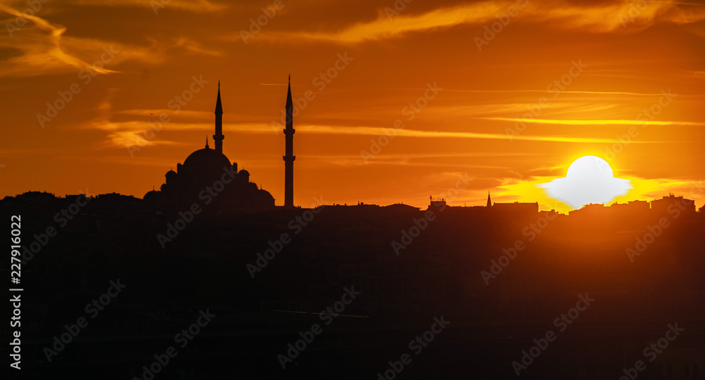 Evening atmosphere with dramatic sky over the dome and minarets of a mosque