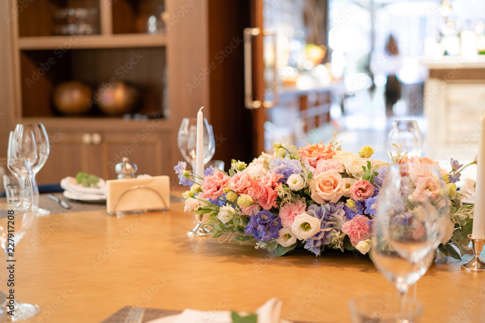 beautiful flower arrangement. Wedding Banquet or gala dinner. The chairs and table for guests, served with cutlery and crockery. beautiful flower arrangement. Wedding Banquet or gala dinner. The chairs and table for guests, served with cutlery and crockery.