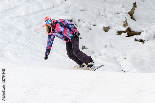 Wallpaper Mural Beautiful young woman snowboarding on the snowy ski slopes on a winter day in the Alps in the Brandnertal, Vorarlberg Austria Torontodigital.ca