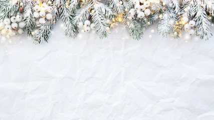 Christmas and New Year holiday background. Xmas greeting card. Spruce tree on white creased background.