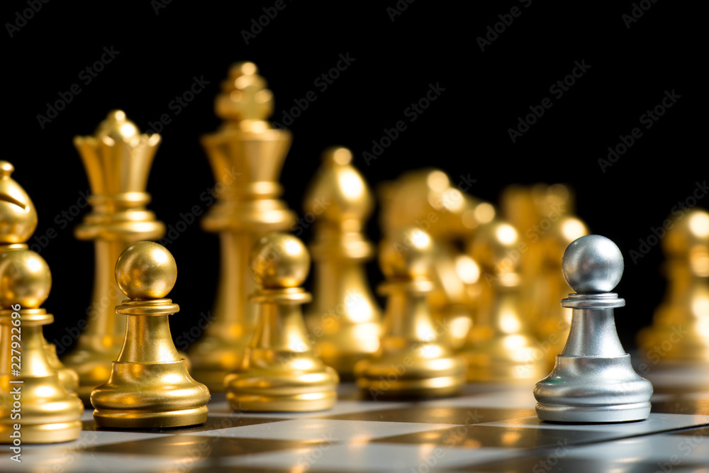 Silver pawn chess piece face with another gold team (Concept for company strategy, business decision and encounter the problem) Silver pawn chess piece face with another gold team (Concept for company strategy, business decision and encounter the problem)
