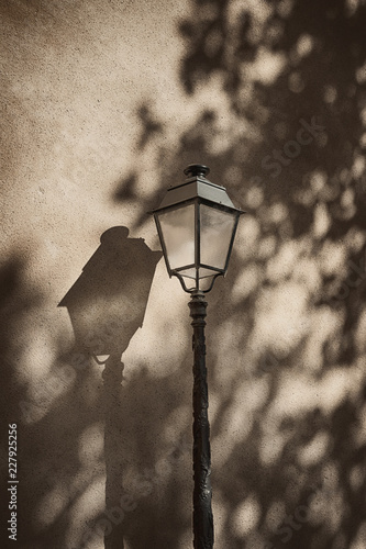 Lantern and its shadow on a wall. Details. Colmar, France