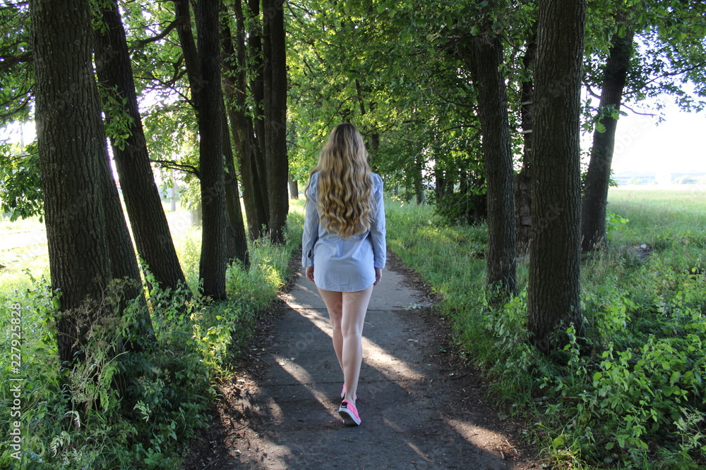young woman walking in the forest young woman walking in the forest