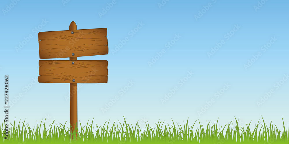 Fototapeta premium wooden sign in grass with copy space for your message