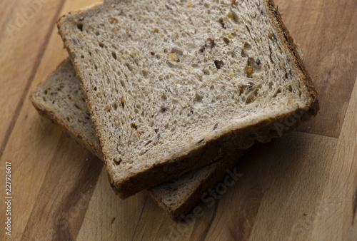 Two pieces of toast on wooden table photo