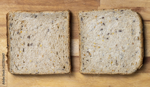 Two pieces of toast on wooden table photo