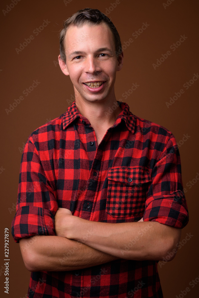 Studio shot of man against brown background Studio shot of man against brown background