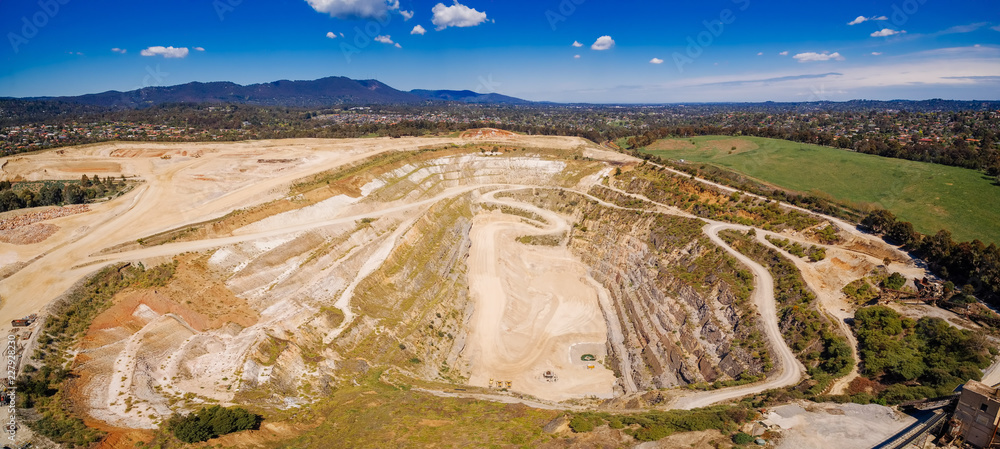 Aerial panorama of decommissioned mine pit and mountains