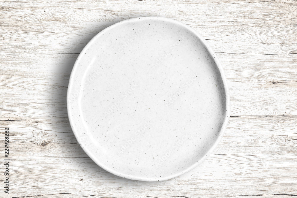Top view of empty white food dish on a wooden background. Top view of empty white food dish on a wooden background.