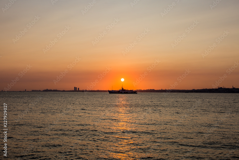Sailing ship on sunset background