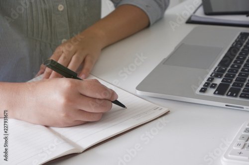 Cropped image of professional businesswoman working at her office via laptop young female manager using portable computer device .