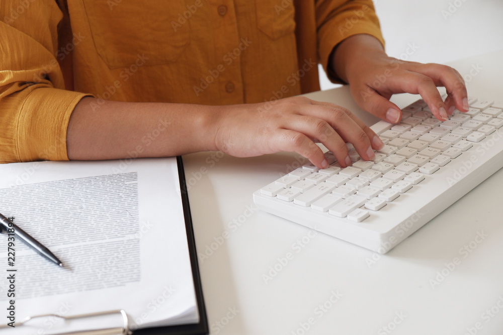 Close-up of female hands. typing in her office. Close-up of female hands. typing in her office.