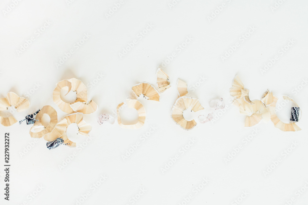 Pencil shavings on white background. Flat lay, top view. Pencil shavings on white background. Flat lay, top view.