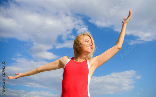 Girl pleased with freedom looks relaxed carefree blue sky background. Take it easy. Woman blonde relaxing outdoors. Take minute care about your wellbeing and harmony. Feel harmony and peace