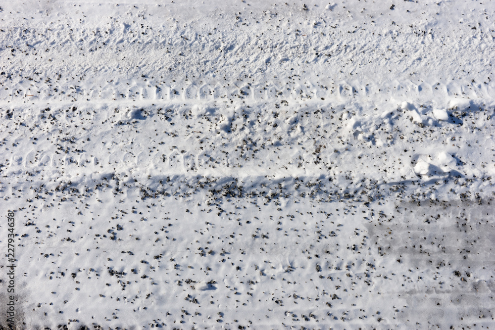 Snow with small pebbles on the street. Winter background Snow with small pebbles on the street. Winter background