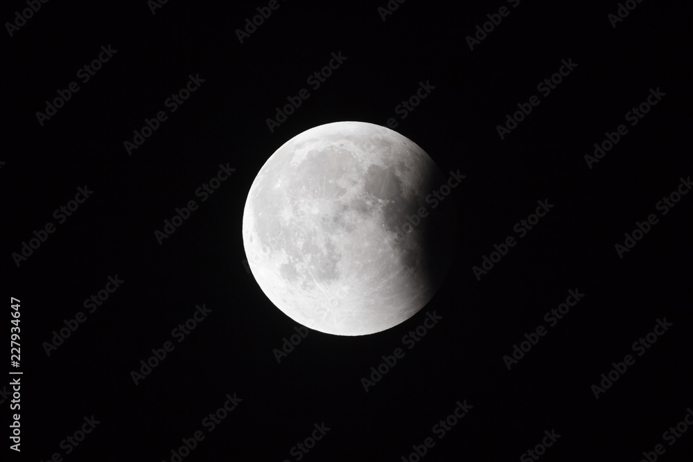 Super Bloody Moon, full eclipse last phase against black sky background, small part of Moon surface covered by Earth's shadow Super Bloody Moon, full eclipse last phase against black sky background, small part of Moon surface covered by Earth's shadow