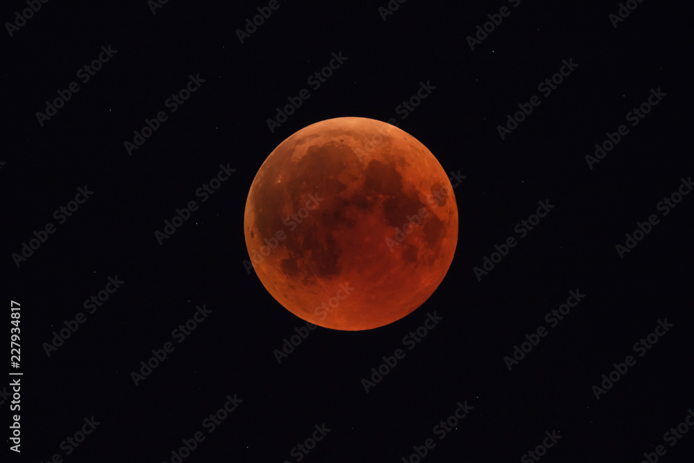 Super Bloody Moon, full eclipse phase against starry sky background Super Bloody Moon, full eclipse phase against starry sky background