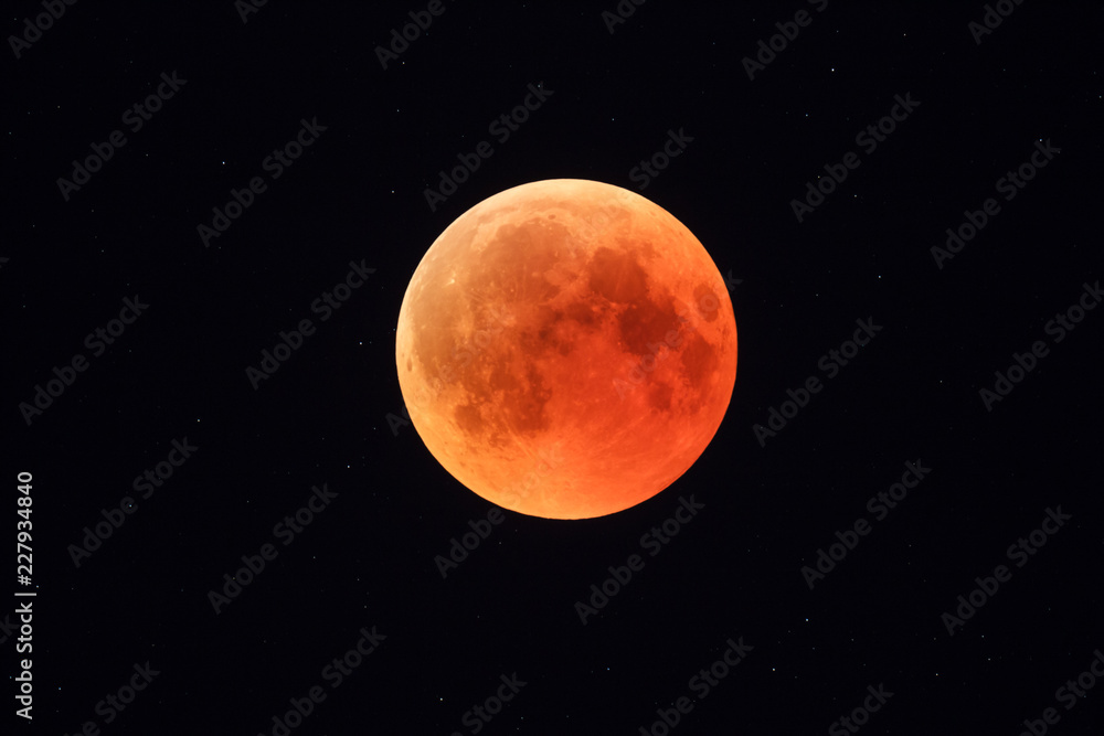 Super Bloody Moon, full eclipse phase against starry sky background