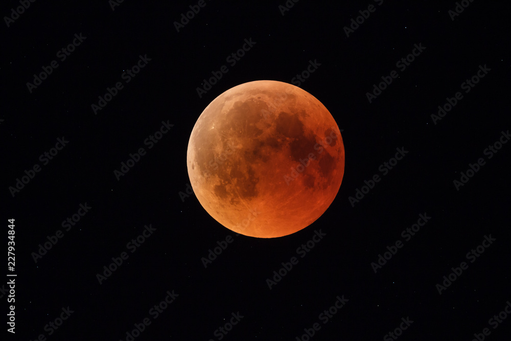 Super Bloody Moon, full eclipse phase against starry sky background Super Bloody Moon, full eclipse phase against starry sky background