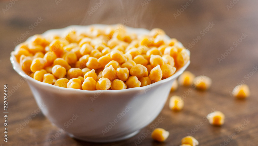 closeup of a bowl with boiled chickpeas on wooden table background closeup of a bowl with boiled chickpeas on wooden table background