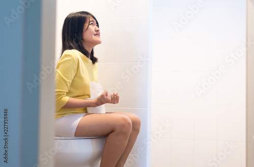 Woman stranglehold sufferring with Hemorrhoids,Constipation,Diarrhea and sitting on toilet