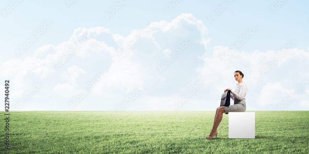 Attractive business lady or accountant outdoors on white box Attractive business lady or accountant outdoors on white box