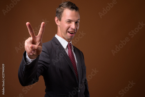 Studio shot of businessman against brown background