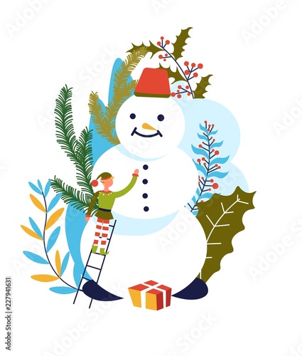 Elf Santa Claus assistant building snowman with carrot nose