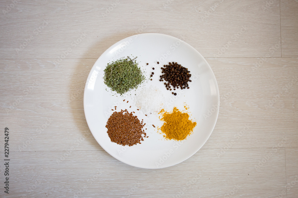 White plate with spices in the kitchen White plate with spices in the kitchen