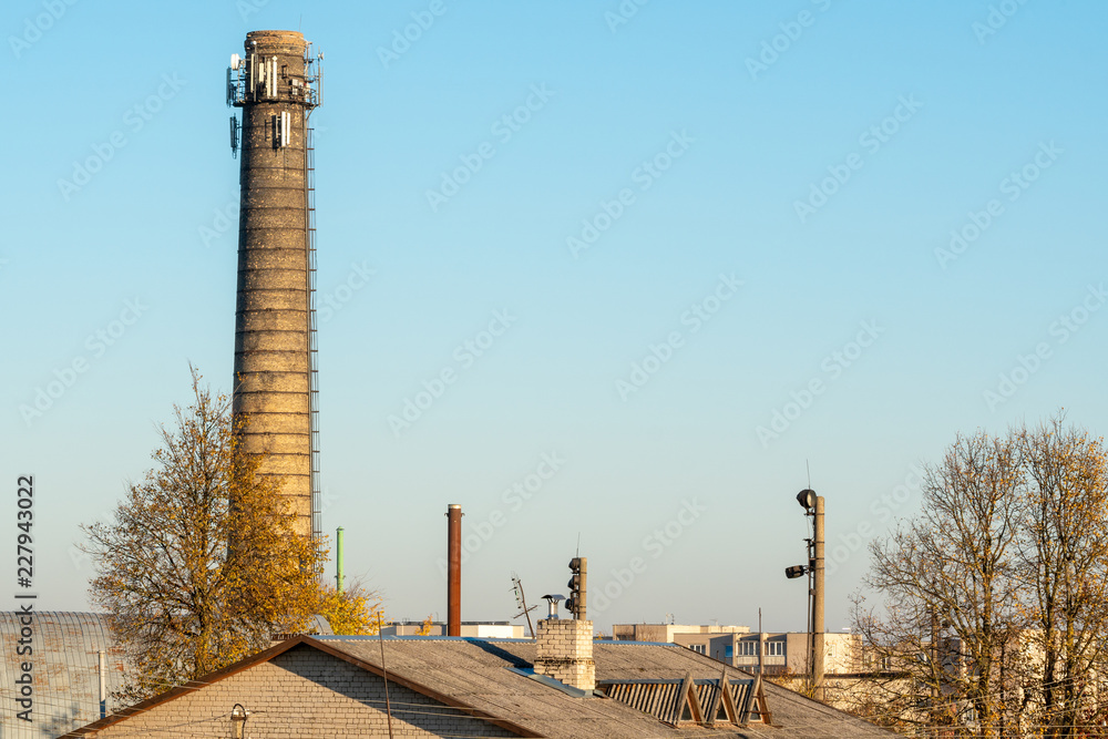 Chimney over urban roofs