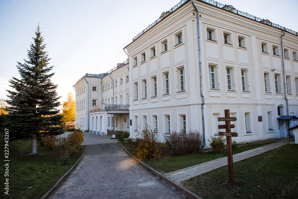 The estate of the Goncharov in Polotnyanyy Zavod. House Museum of Natalia Goncharova, a historical place associated with Pushkin. White walls of a large stone house in autumn, beautiful autumn nature 