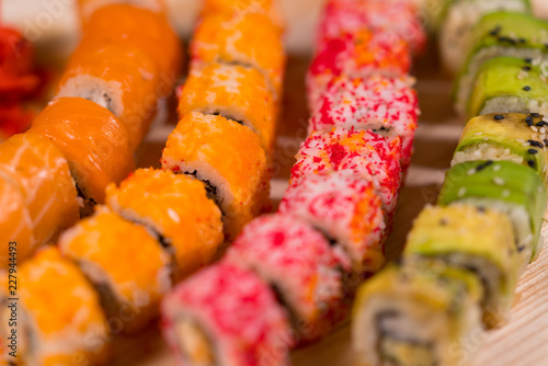 Colorful assortment of sushi rolls on a board