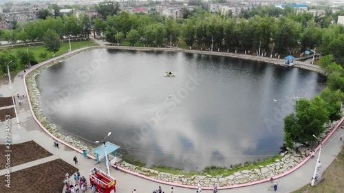 4k Beautiful aerial view of clear emerald lake in city park