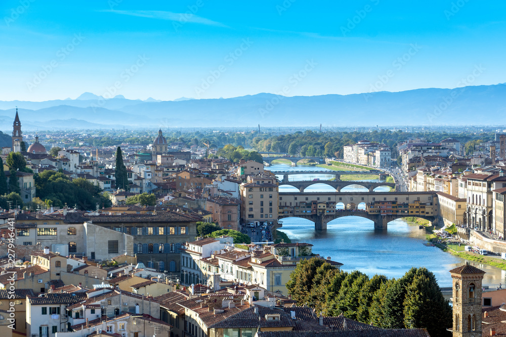 Panoramic view of Florence's skyline before the sunset with the view of the famous Vecchio bridge and the Arno river.