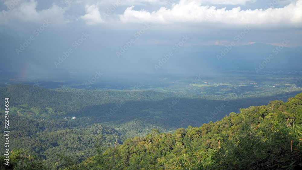 Landscape Mountain valley. Background blue sky with white full of rain clouds.