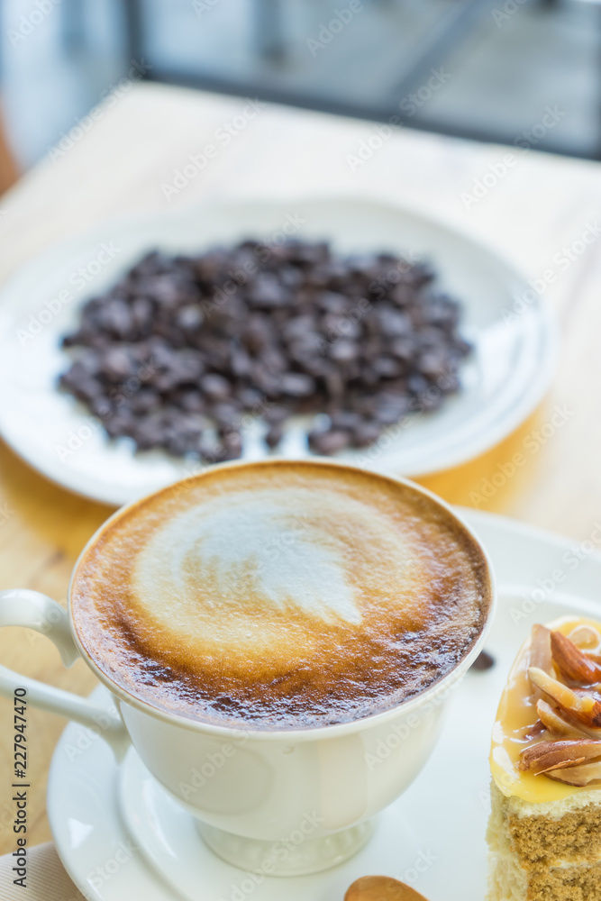 Hot coffee late in white cup on blurred raw coffee seed background, Hot coffee late in white cup on blurred raw coffee seed background,