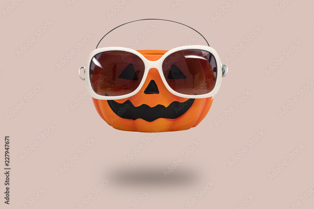 Halloween pumpkin with glasses on pink background. Halloween minimal idea concept Halloween pumpkin with glasses on pink background. Halloween minimal idea concept