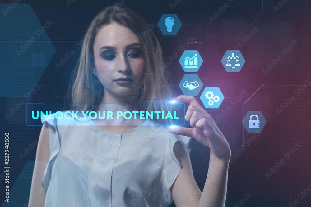 Fototapeta premium The concept of business, technology, the Internet and the network. A young entrepreneur working on a virtual screen of the future and sees the inscription: Unlock your potential