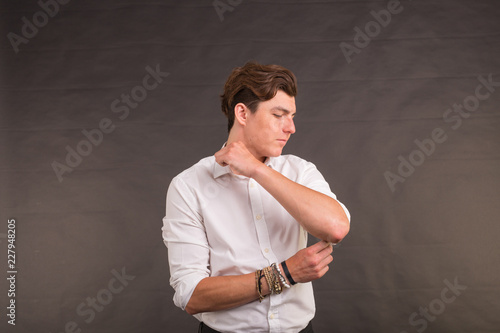 People, style and self-confidence concept - handsome stylish man on brown background photo