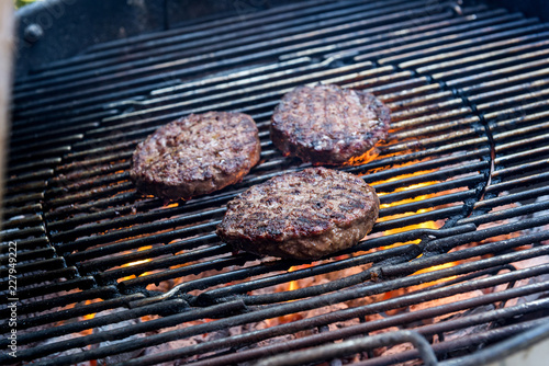 Hamburgers are cooking on the grill