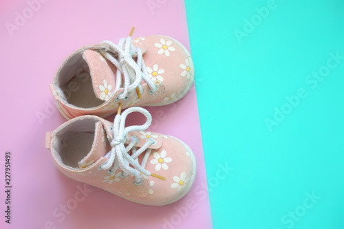 Baby pink shoes on a bright background