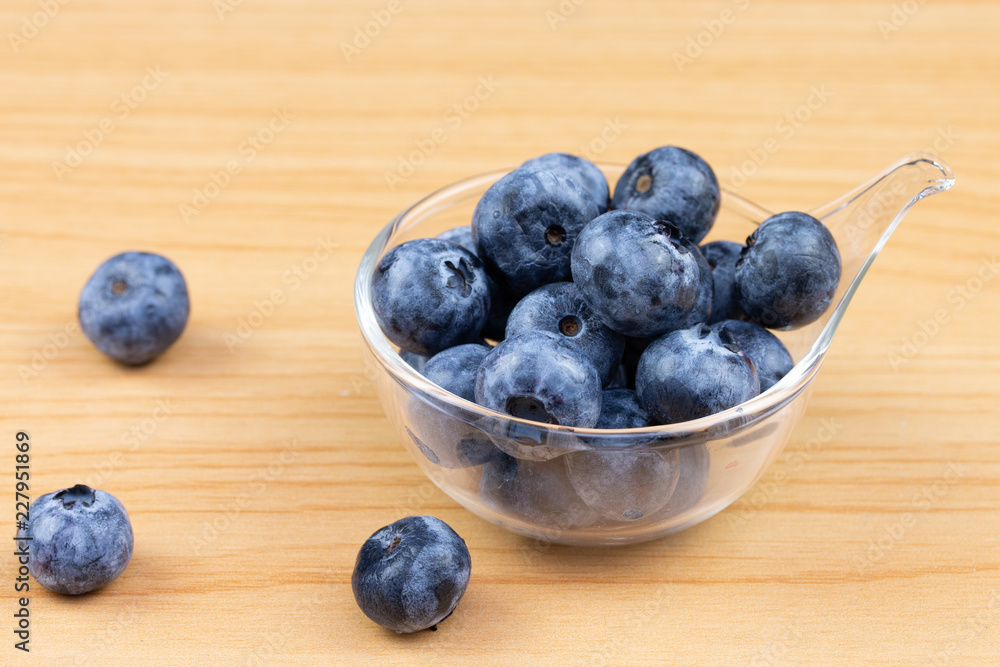 blueberry in cup on wood table background blueberry in cup on wood table background